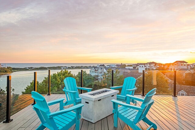 7570 E County Highway 30a, Watersound, FL 32461 - deck at dusk featuring an outdoor fire pit and a water view
