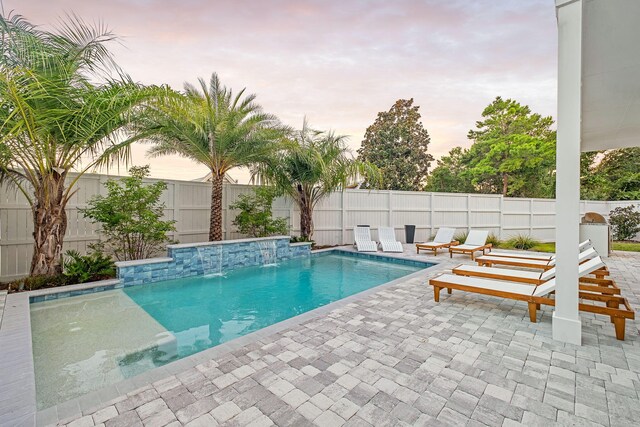 7570 E County Highway 30a, Watersound, FL 32461 - pool at dusk with a patio and a fenced backyard