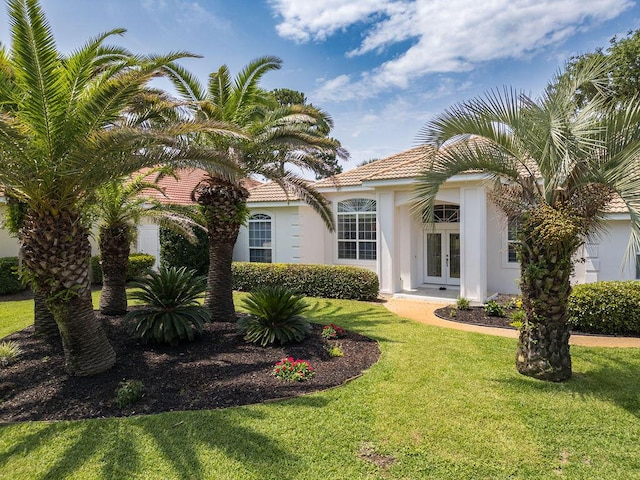 359 Indigo Loop, Miramar Beach, FL 32550 - view of front of property featuring french doors, a front yard, stucco siding, and a tile roof