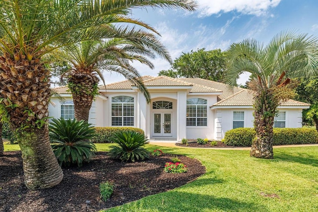 359 Indigo Loop, Miramar Beach, FL 32550 - mediterranean / spanish-style home with french doors, a front yard, stucco siding, and a tile roof