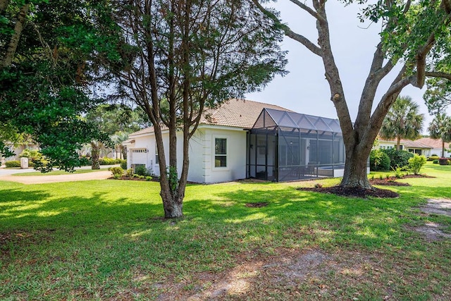 359 Indigo Loop, Miramar Beach, FL 32550 - view of green lawn with an attached garage, a lanai, and driveway