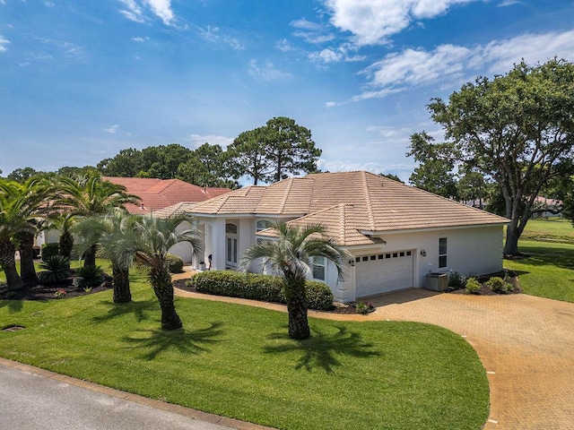 359 Indigo Loop, Miramar Beach, FL 32550 - mediterranean / spanish-style home featuring decorative driveway, an attached garage, a tiled roof, a front yard, and stucco siding