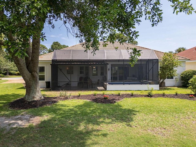 359 Indigo Loop, Miramar Beach, FL 32550 - rear view of house featuring a tiled roof, a yard, glass enclosure, a patio, and stucco siding