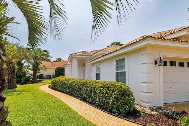 359 Indigo Loop, Miramar Beach, FL 32550 - view of property exterior featuring a garage, stucco siding, a tile roof, and a yard