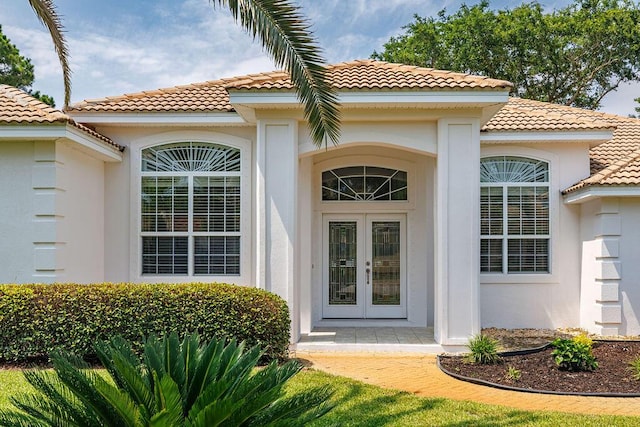 359 Indigo Loop, Miramar Beach, FL 32550 - view of exterior entry with a tiled roof, stucco siding, and french doors