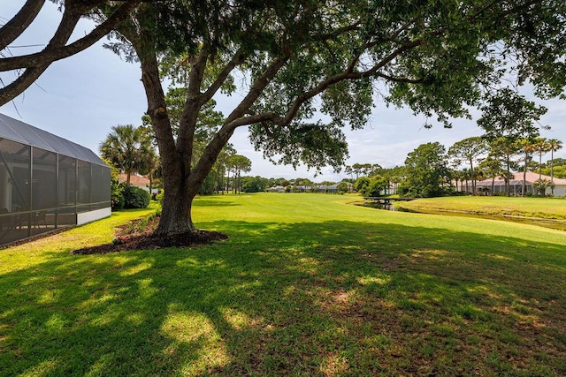 359 Indigo Loop, Miramar Beach, FL 32550 - view of grassy yard featuring a water view and glass enclosure