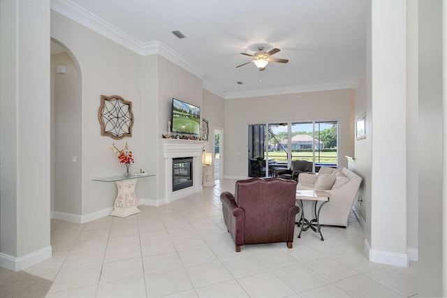359 Indigo Loop, Miramar Beach, FL 32550 - living room with a ceiling fan, a glass covered fireplace, light tile patterned floors, crown molding, and arched walkways