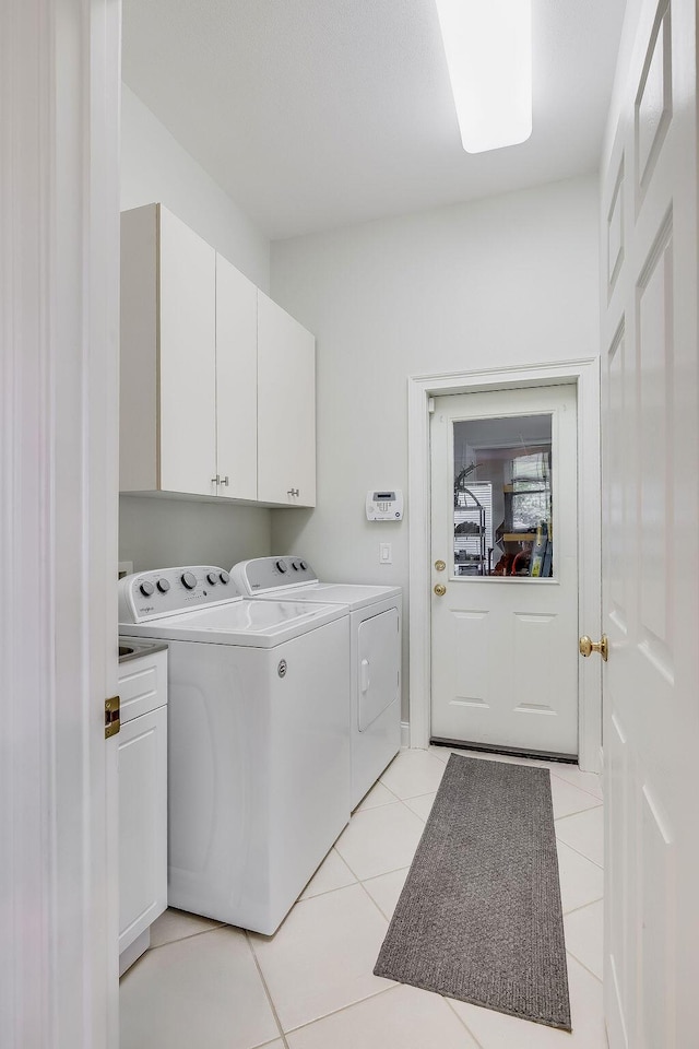 359 Indigo Loop, Miramar Beach, FL 32550 - laundry area featuring independent washer and dryer, cabinet space, and light tile patterned flooring