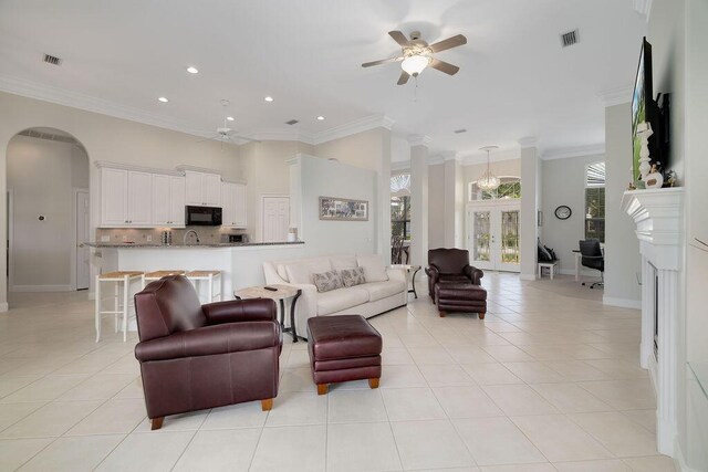359 Indigo Loop, Miramar Beach, FL 32550 - living area featuring a ceiling fan, ornamental molding, arched walkways, recessed lighting, and light tile patterned flooring