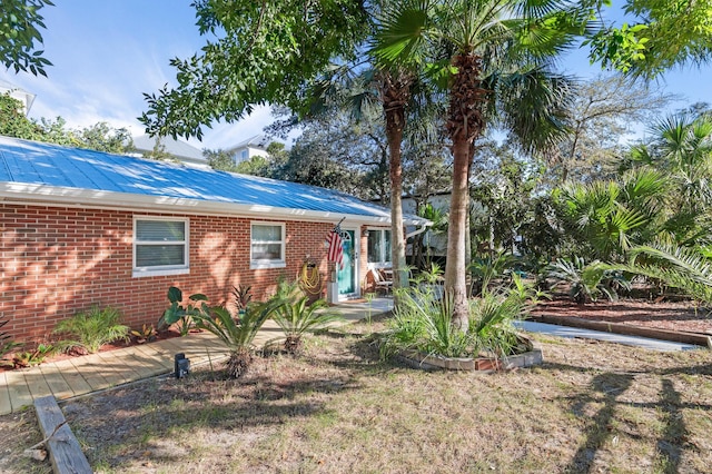 40 Flounder St, Santa Rosa Beach, FL 32459 - view of front facade featuring brick siding and metal roof