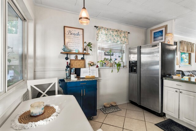 40 Flounder St, Santa Rosa Beach, FL 32459 - kitchen featuring stainless steel fridge with ice dispenser, white cabinets, light tile patterned flooring, ornamental molding, and pendant lighting