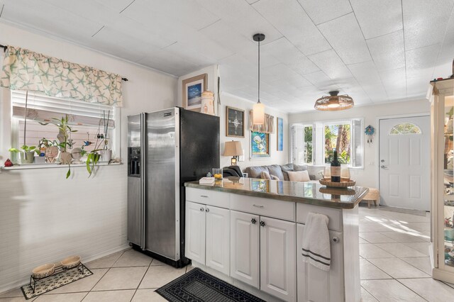 40 Flounder St, Santa Rosa Beach, FL 32459 - kitchen featuring stainless steel fridge, light tile patterned floors, a peninsula, white cabinets, and pendant lighting
