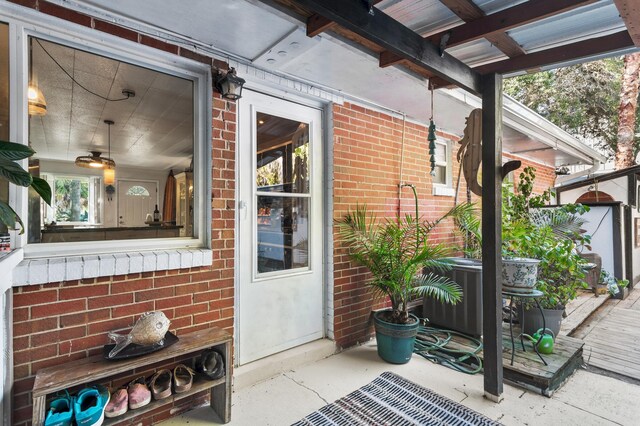 40 Flounder St, Santa Rosa Beach, FL 32459 - view of exterior entry featuring brick siding and central AC unit