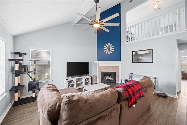 1176 Lost Trl, Fort Walton Beach, FL 32547 - living area with a tile fireplace, a ceiling fan, wood finished floors, high vaulted ceiling, and baseboards
