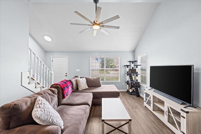 1176 Lost Trl, Fort Walton Beach, FL 32547 - living area with stairs, wood finished floors, a ceiling fan, baseboards, and vaulted ceiling