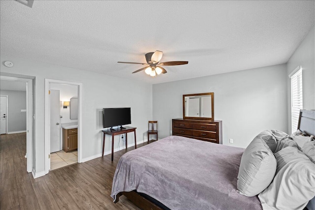 1176 Lost Trl, Fort Walton Beach, FL 32547 - bedroom with dark wood-type flooring, a textured ceiling, a ceiling fan, connected bathroom, and baseboards