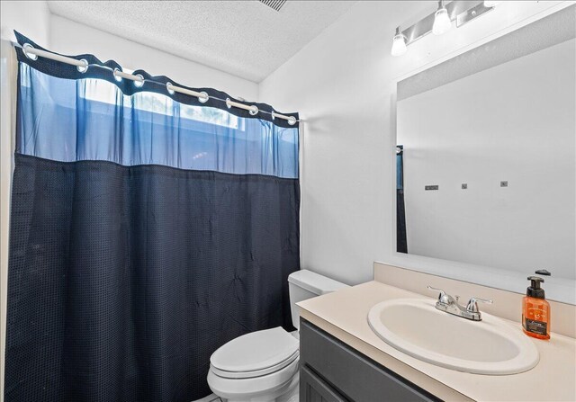 1176 Lost Trl, Fort Walton Beach, FL 32547 - bathroom with a textured ceiling, toilet, vanity, and curtained shower