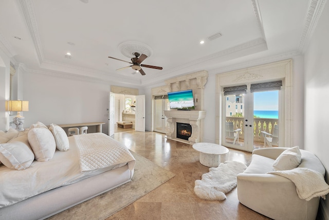 30 Pelican Cir, Inlet Beach, FL 32461 - bedroom featuring a tray ceiling, access to exterior, ornamental molding, a lit fireplace, and a ceiling fan