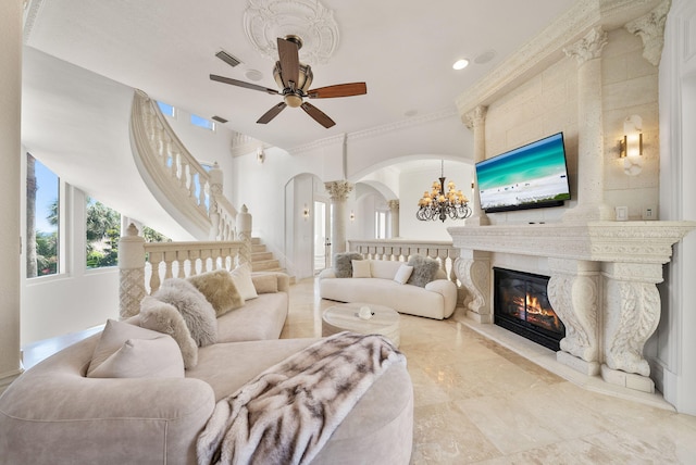 30 Pelican Cir, Inlet Beach, FL 32461 - living area with arched walkways, a chandelier, a glass covered fireplace, ceiling fan, and recessed lighting