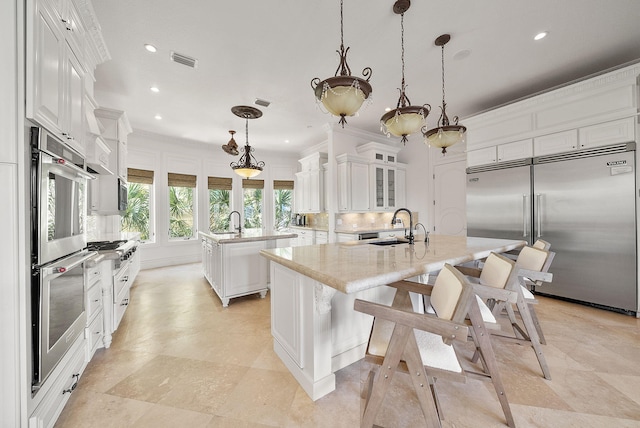 30 Pelican Cir, Inlet Beach, FL 32461 - kitchen with an island with sink, stainless steel appliances, a sink, tasteful backsplash, and recessed lighting