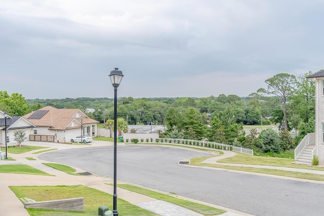 409 Hideaway Ln, Niceville, FL 32578 - view of asphalt road with sidewalks, street lights, and curbs