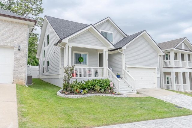 409 Hideaway Ln, Niceville, FL 32578 - view of front of house with covered porch, driveway, a front yard, and roof with shingles