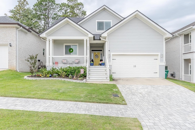 409 Hideaway Ln, Niceville, FL 32578 - view of front facade featuring a porch, decorative driveway, and a front yard