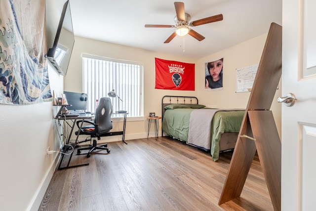 409 Hideaway Ln, Niceville, FL 32578 - bedroom with wood finished floors, multiple windows, a desk, and a ceiling fan
