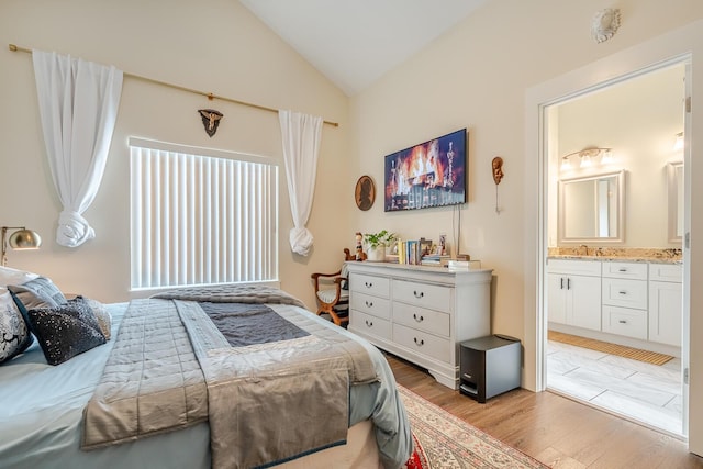 409 Hideaway Ln, Niceville, FL 32578 - bedroom featuring lofted ceiling, connected bathroom, and light wood-style floors