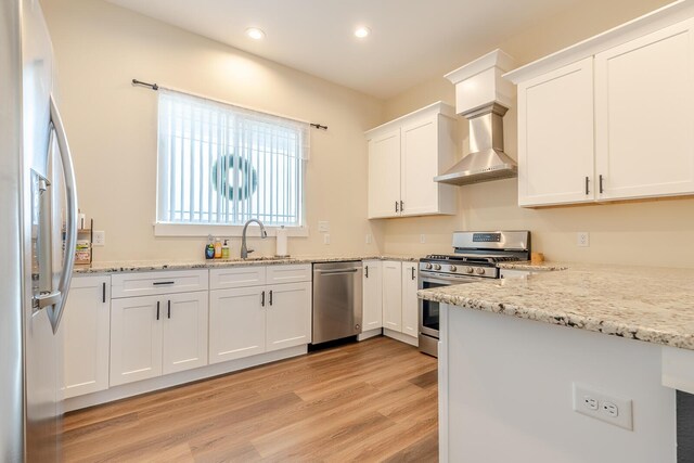 409 Hideaway Ln, Niceville, FL 32578 - kitchen with stainless steel appliances, light wood finished floors, recessed lighting, white cabinetry, and light stone counters