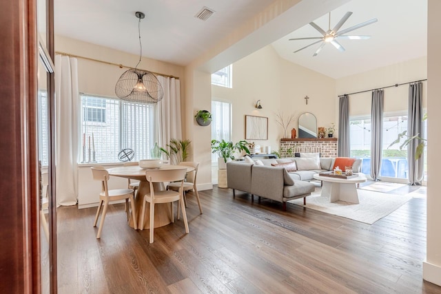 409 Hideaway Ln, Niceville, FL 32578 - dining space with plenty of natural light, high vaulted ceiling, a ceiling fan, and wood finished floors
