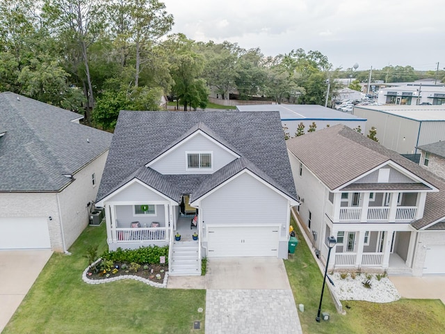 409 Hideaway Ln, Niceville, FL 32578 - view of front of home featuring covered porch, roof with shingles, driveway, and a front yard