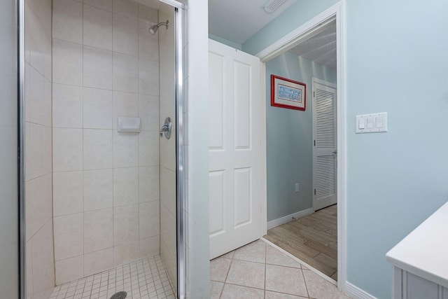 1515 SE Miracle Strip Pkwy Unit 613, Fort Walton Beach, FL 32548 - full bathroom featuring a stall shower, tile patterned flooring, baseboards, and vanity