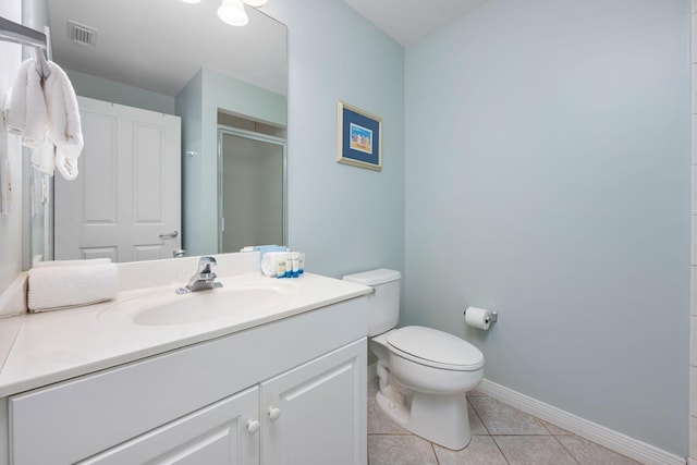 1515 SE Miracle Strip Pkwy Unit 613, Fort Walton Beach, FL 32548 - full bathroom with vanity, toilet, a stall shower, baseboards, and tile patterned floors
