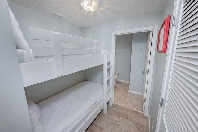 1515 SE Miracle Strip Pkwy Unit 613, Fort Walton Beach, FL 32548 - bedroom featuring light wood-style flooring and a textured ceiling