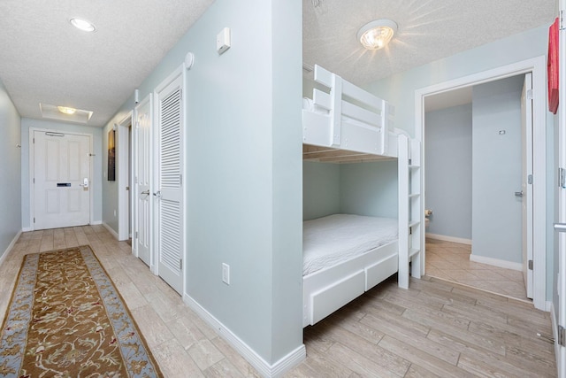 1515 SE Miracle Strip Pkwy Unit 613, Fort Walton Beach, FL 32548 - corridor featuring a textured ceiling, light wood finished floors, baseboards, and recessed lighting
