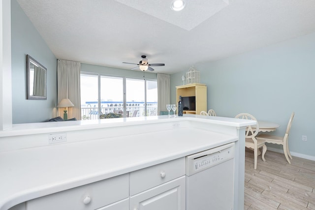 1515 SE Miracle Strip Pkwy Unit 613, Fort Walton Beach, FL 32548 - kitchen featuring white dishwasher, light wood-style flooring, a ceiling fan, baseboards, and light countertops