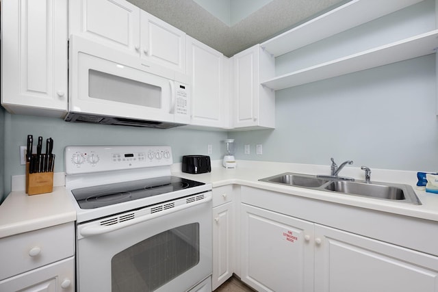 1515 SE Miracle Strip Pkwy Unit 613, Fort Walton Beach, FL 32548 - kitchen with white appliances, a sink, white cabinetry, and light countertops
