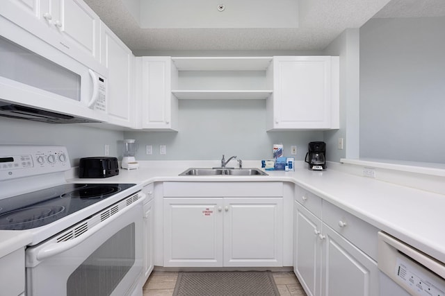 1515 SE Miracle Strip Pkwy Unit 613, Fort Walton Beach, FL 32548 - kitchen featuring white appliances, a sink, white cabinetry, open shelves, and light countertops