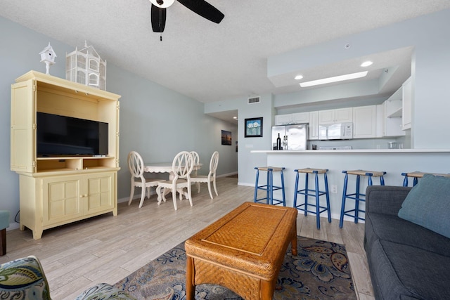 1515 SE Miracle Strip Pkwy Unit 613, Fort Walton Beach, FL 32548 - living area featuring light wood finished floors, a ceiling fan, a textured ceiling, recessed lighting, and baseboards