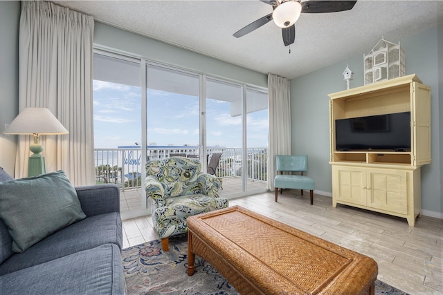 1515 SE Miracle Strip Pkwy Unit 613, Fort Walton Beach, FL 32548 - living room with a ceiling fan, plenty of natural light, a textured ceiling, wood finished floors, and baseboards
