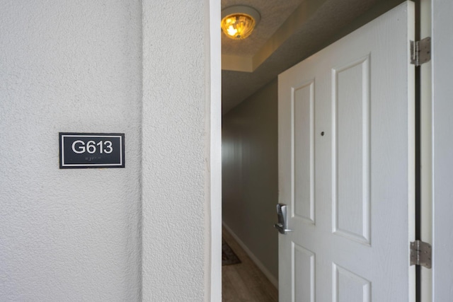 1515 SE Miracle Strip Pkwy Unit 613, Fort Walton Beach, FL 32548 - detailed view of wood finished floors, a textured wall, and baseboards