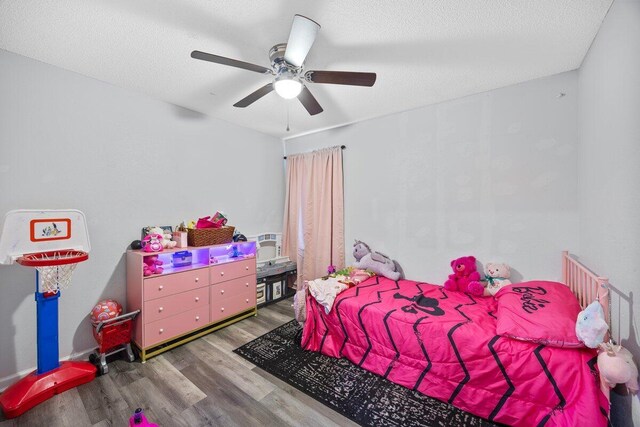 4887 Martina Way, Gulf Breeze, FL 32563 - bedroom with wood finished floors, ceiling fan, and a textured ceiling