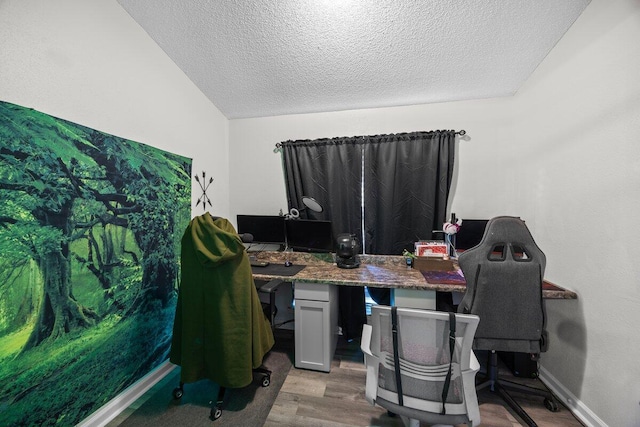 4887 Martina Way, Gulf Breeze, FL 32563 - office with a textured ceiling, wood finished floors, vaulted ceiling, and baseboards