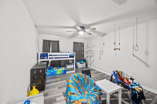 4887 Martina Way, Gulf Breeze, FL 32563 - playroom featuring a ceiling fan, a textured ceiling, wood finished floors, and baseboards