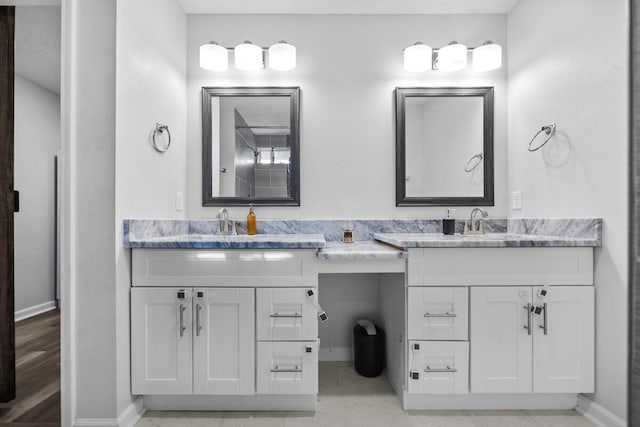 4887 Martina Way, Gulf Breeze, FL 32563 - bathroom with double vanity and baseboards