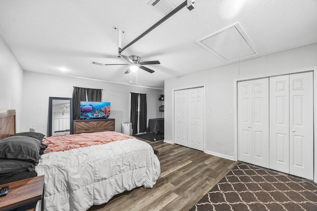 4887 Martina Way, Gulf Breeze, FL 32563 - bedroom featuring attic access, wood finished floors, two closets, a textured ceiling, and ceiling fan
