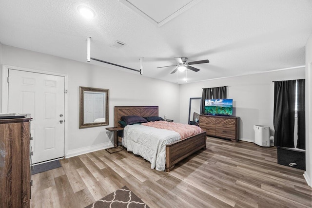 4887 Martina Way, Gulf Breeze, FL 32563 - bedroom featuring wood finished floors, baseboards, a textured ceiling, and a ceiling fan
