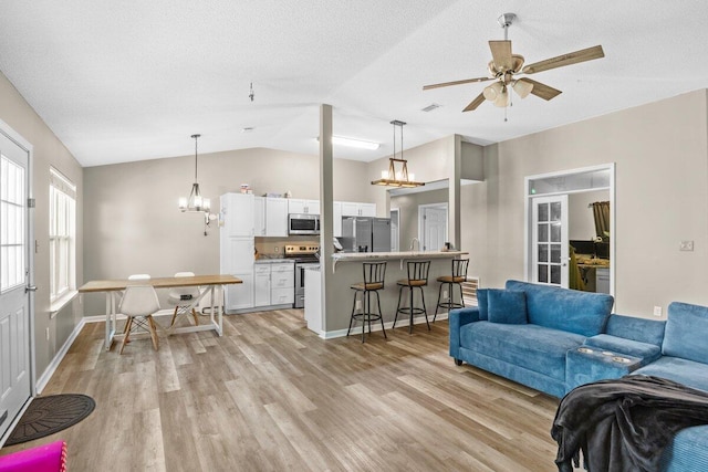 4887 Martina Way, Gulf Breeze, FL 32563 - living area with light wood-style floors, vaulted ceiling, a chandelier, ceiling fan, and baseboards