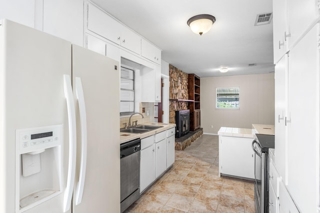 814 Tuxedo Dr, Fort Walton Beach, FL 32547 - kitchen with stainless steel appliances, a sink, white cabinets, and tile counters